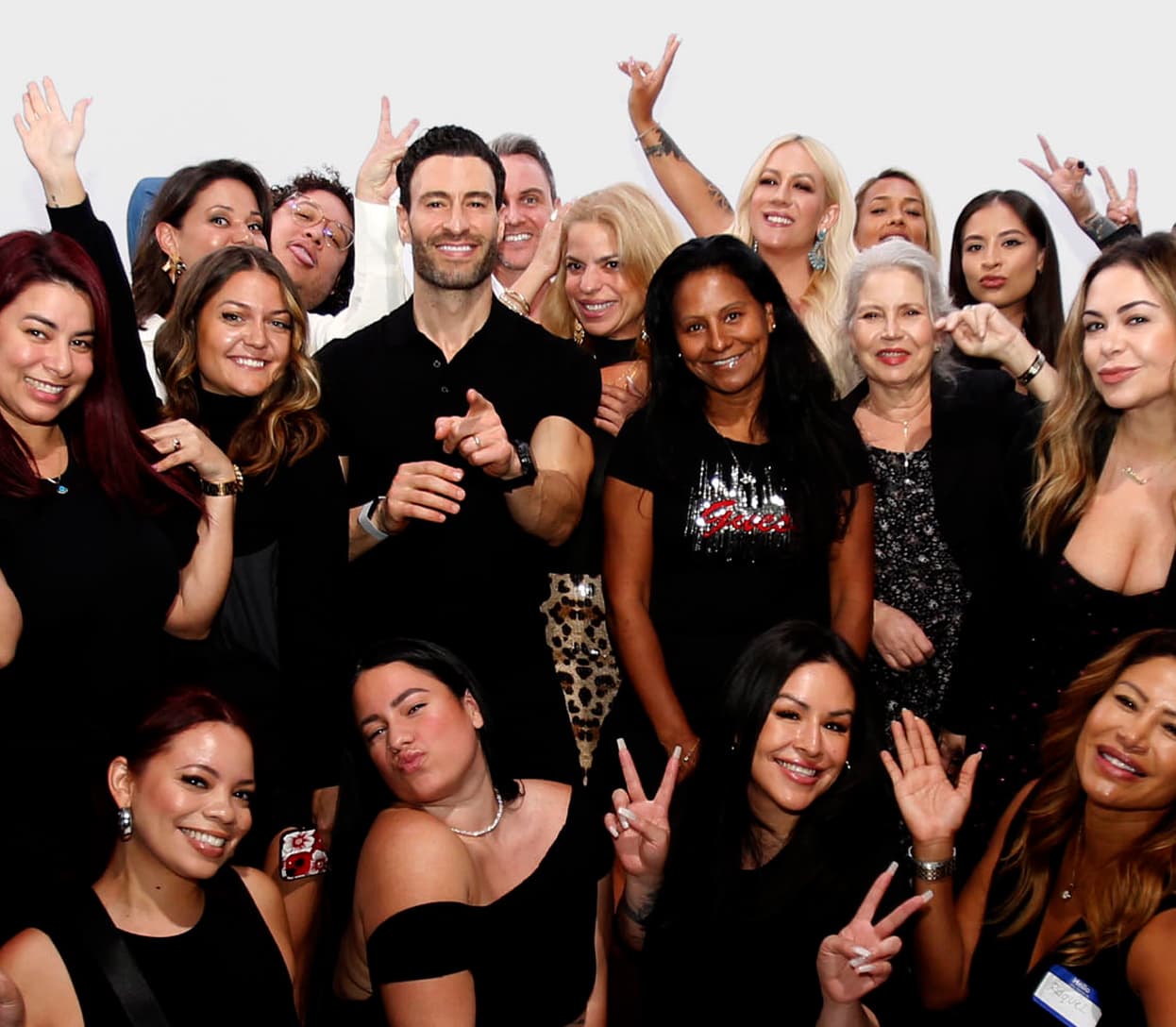 A group of vetted Glamsquad hair stylists, makeup artists and nail techs posing together and smiling